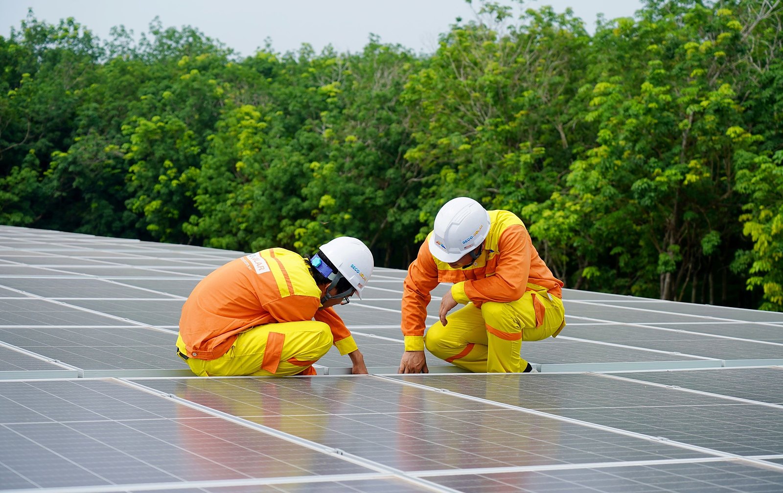 Technicians checking a rooftop solar array